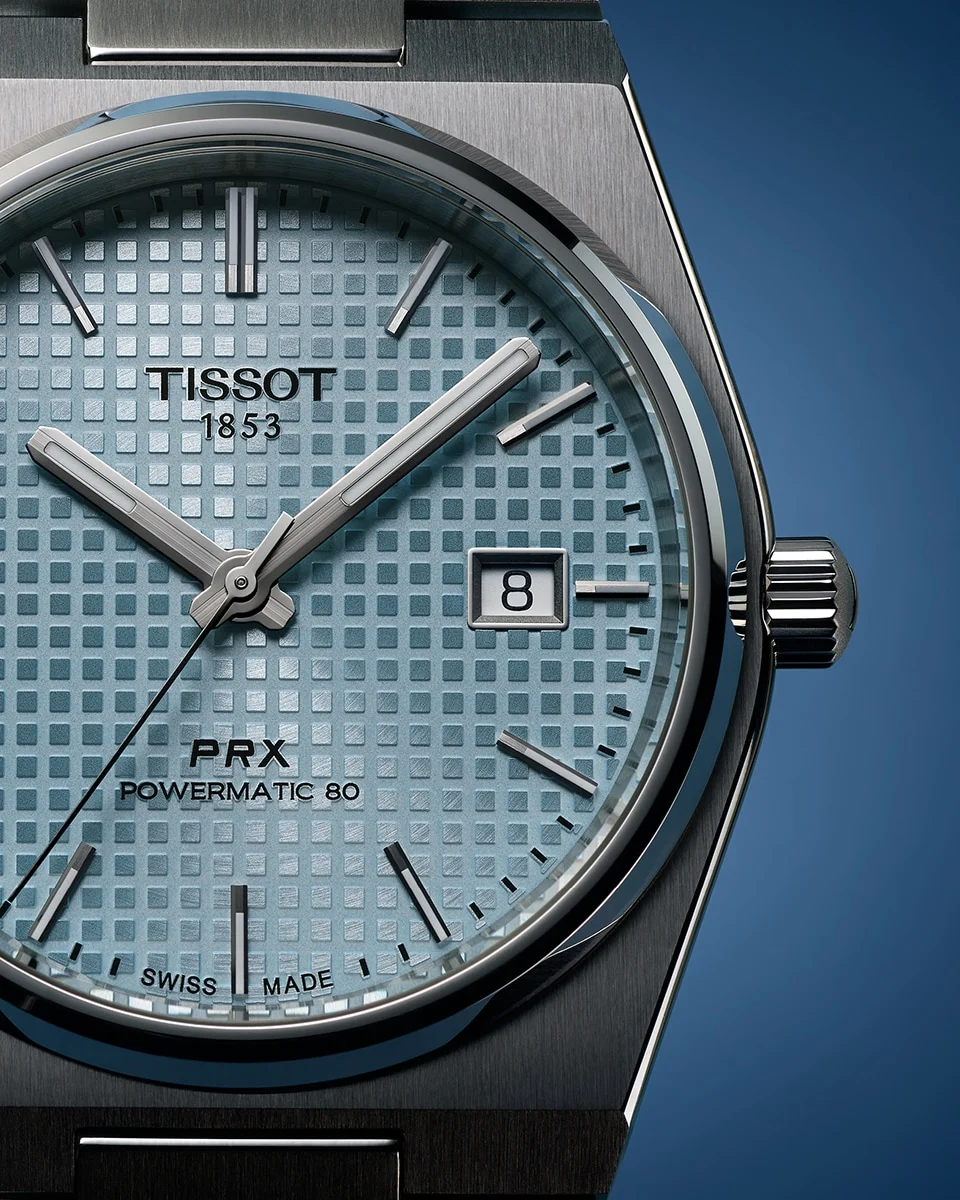 Close-up of a Tissot PRX Powermatic 80 with a light blue dial