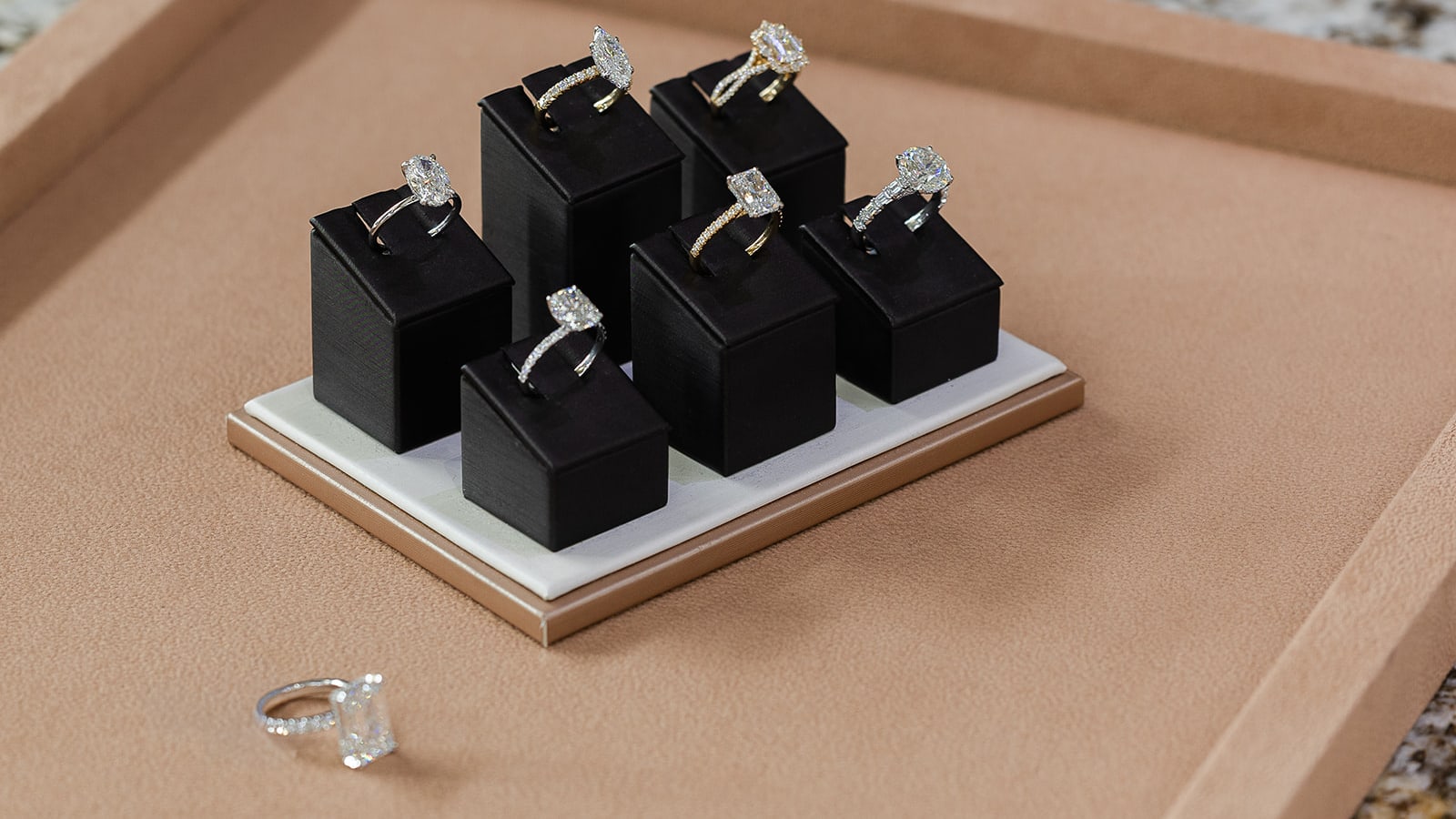 Selection of fine rings on a black showroom display in the Giganti & Giganti Springfield, IL showroom
